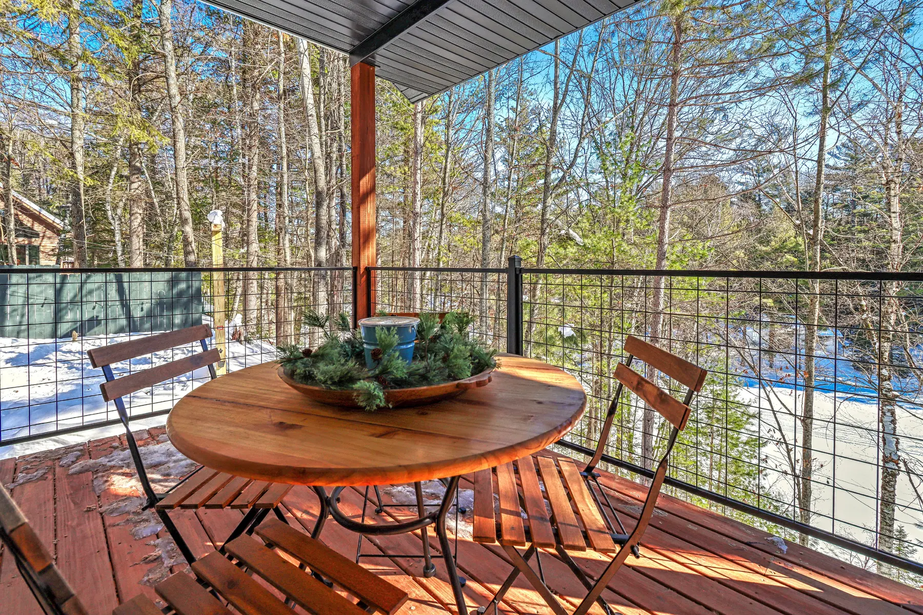 One of three covered porches overlooking the trees